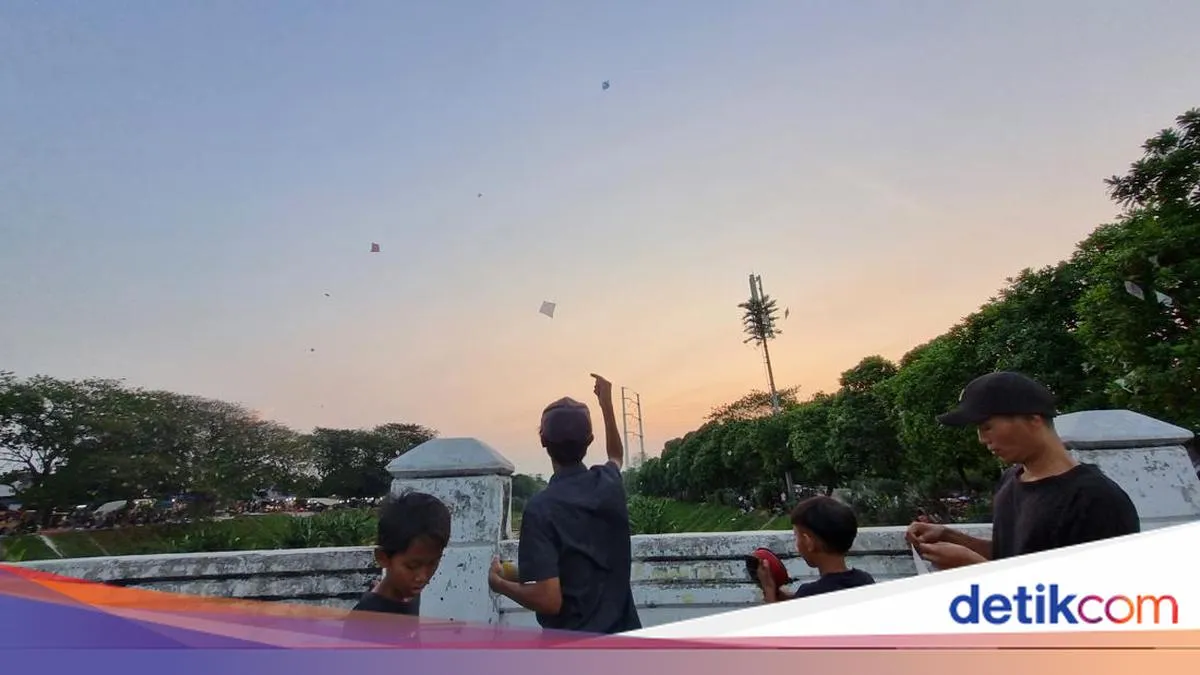 Warga Cipinang Nikmati Sore Bermain Layangan di Banjir Kanal Timur